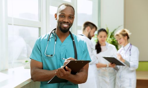 Healthcare people group. Professional male doctor at hospital or clinic with other medical professionals.